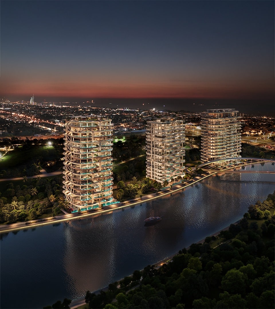 Casa AHS towers illuminated at night on the Dubai Water Canal marking an AHS Properties 2025 milestone